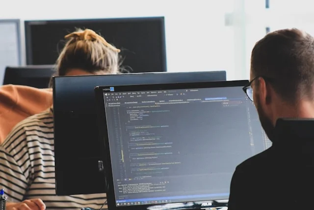 Development: two developers reviewing code at a desk
